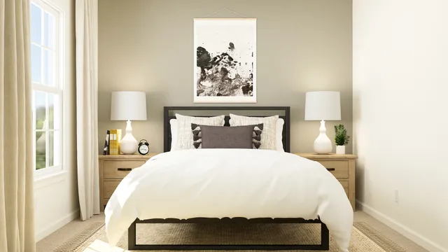 a bedroom with a bed and a painting on the wall