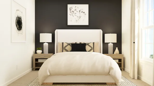 a large bed sitting in a bedroom next to a window