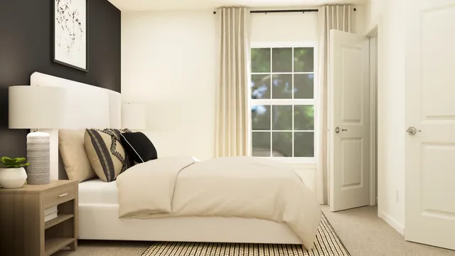 a bedroom with a bed and a window