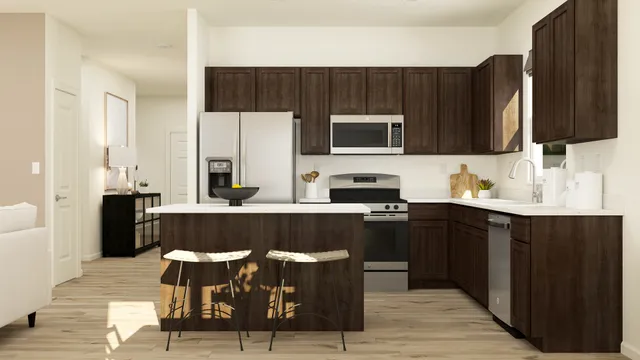 a kitchen with stainless steel appliances a stove top oven a sink dishwasher and a refrigerator with wooden floor