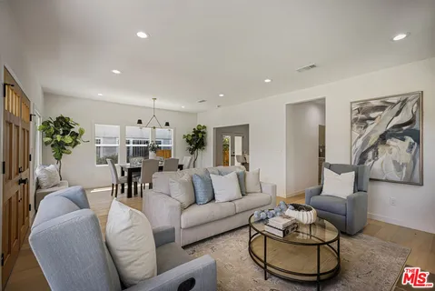 a living room with furniture and wooden floor