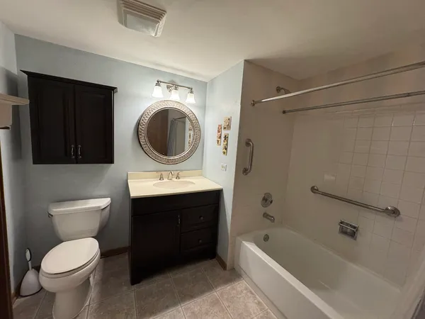 a bathroom with a sink a toilet and bathtub