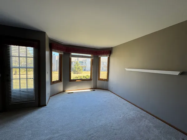 a view of a room with windows and chandelier