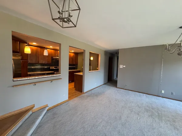 a view of a kitchen with a sink and an empty room