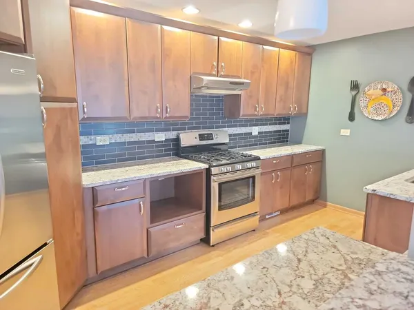 a kitchen with a stove top oven cabinets and a counter top space