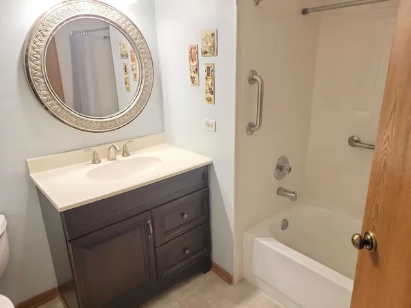 a bathroom with a sink a mirror and a bathtub