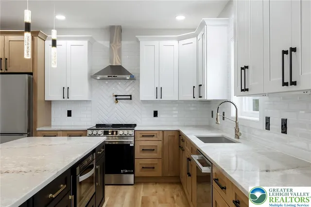a kitchen with granite countertop white cabinets and window