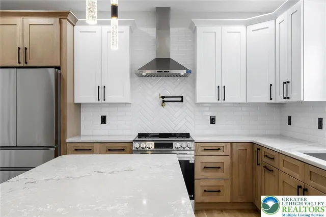 a kitchen with a sink a counter space and wooden floor