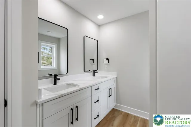 an empty room with windows and ceiling fan