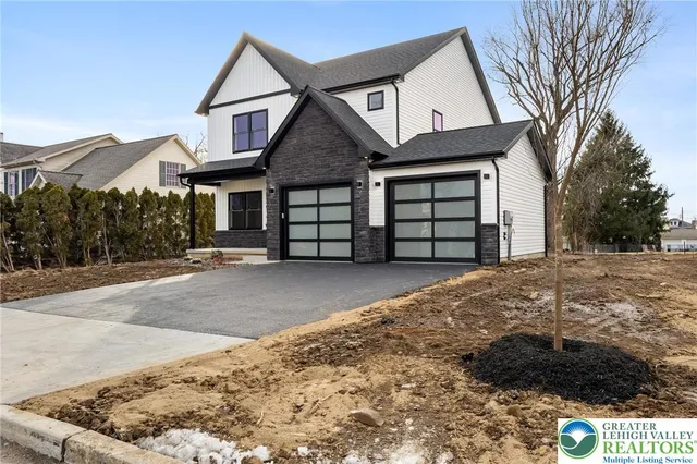 a front view of a house with a yard and garage