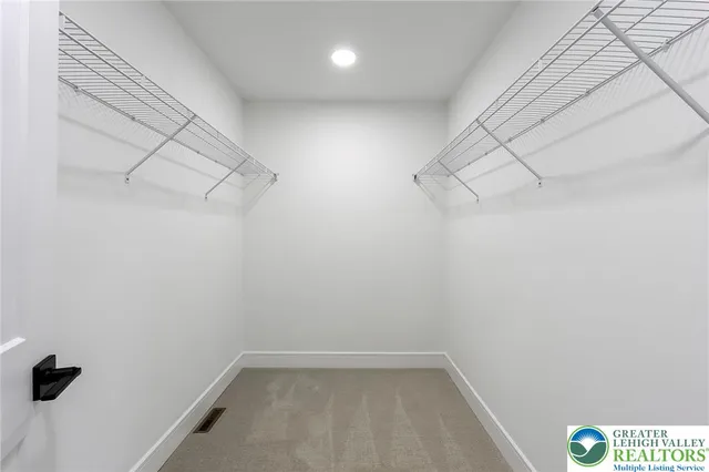 a spacious bathroom with a double vanity sink a mirror and a bathtub