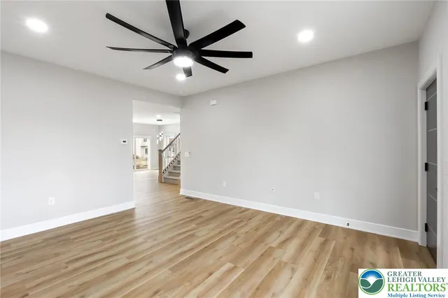 a view of hallway with wooden floor