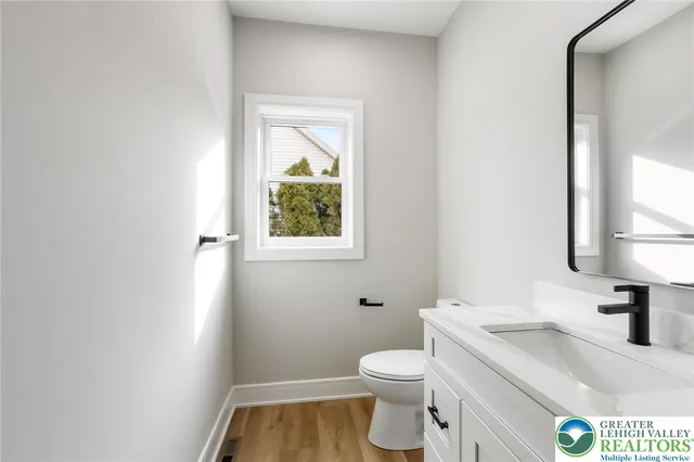 a view of entryway with wooden floor and front door