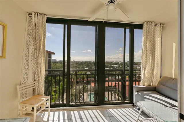 a living room filled with furniture and a floor to ceiling window