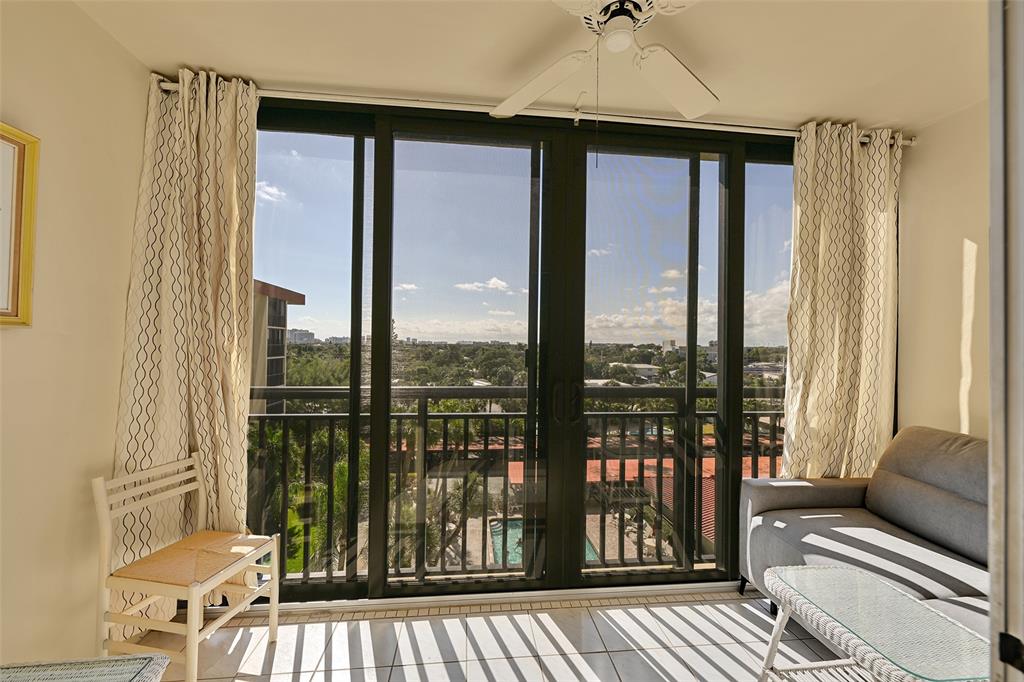 2350 Northeast 14th Street Causeway, Unit 609 Pompano Beach, FL 33062 - Photo 11 of 42 a living room filled with furniture and a floor to ceiling window