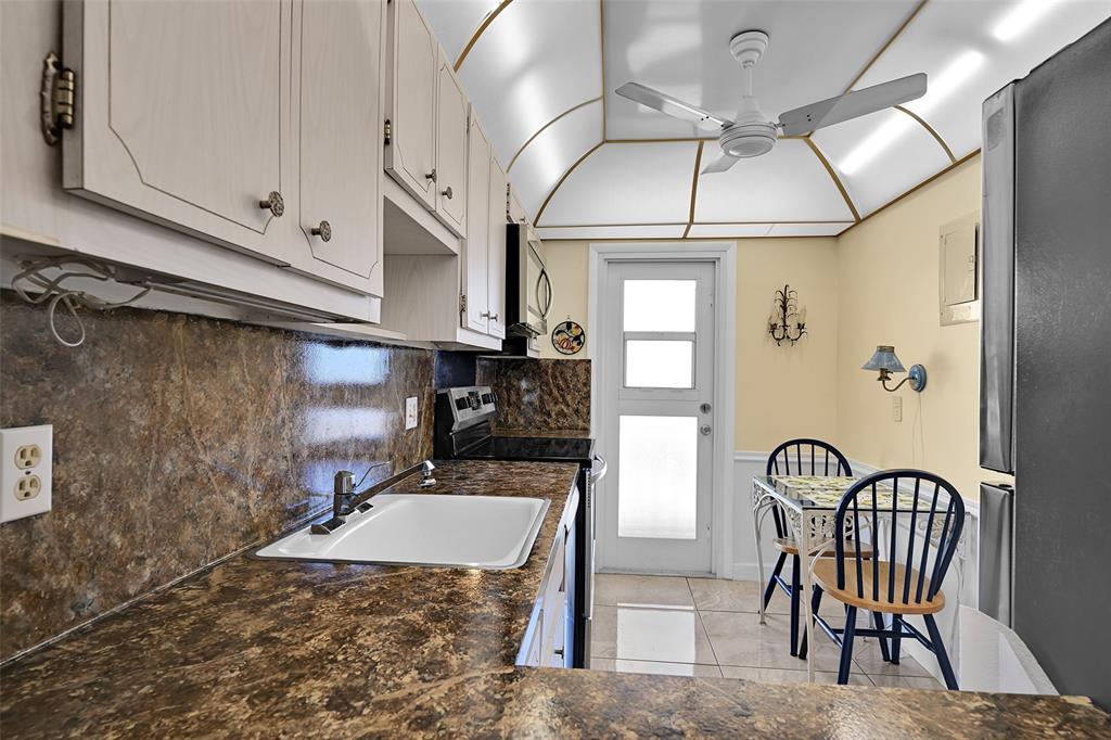 2350 Northeast 14th Street Causeway, Unit 609 Pompano Beach, FL 33062 - Photo 13 of 42 a bathroom with a sink a mirror and a bathtub