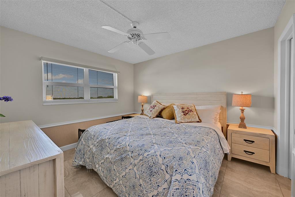 2350 Northeast 14th Street Causeway, Unit 609 Pompano Beach, FL 33062 - Photo 14 of 42 a bedroom with a bed and a night stand