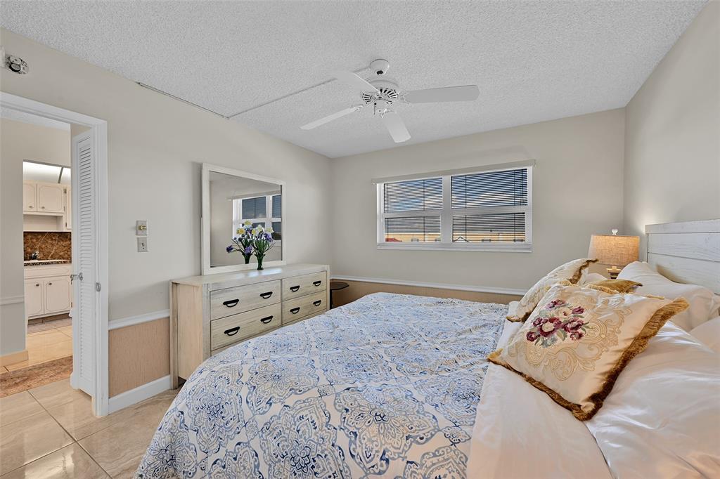 2350 Northeast 14th Street Causeway, Unit 609 Pompano Beach, FL 33062 - Photo 15 of 42 a bedroom with a bed and a dresser