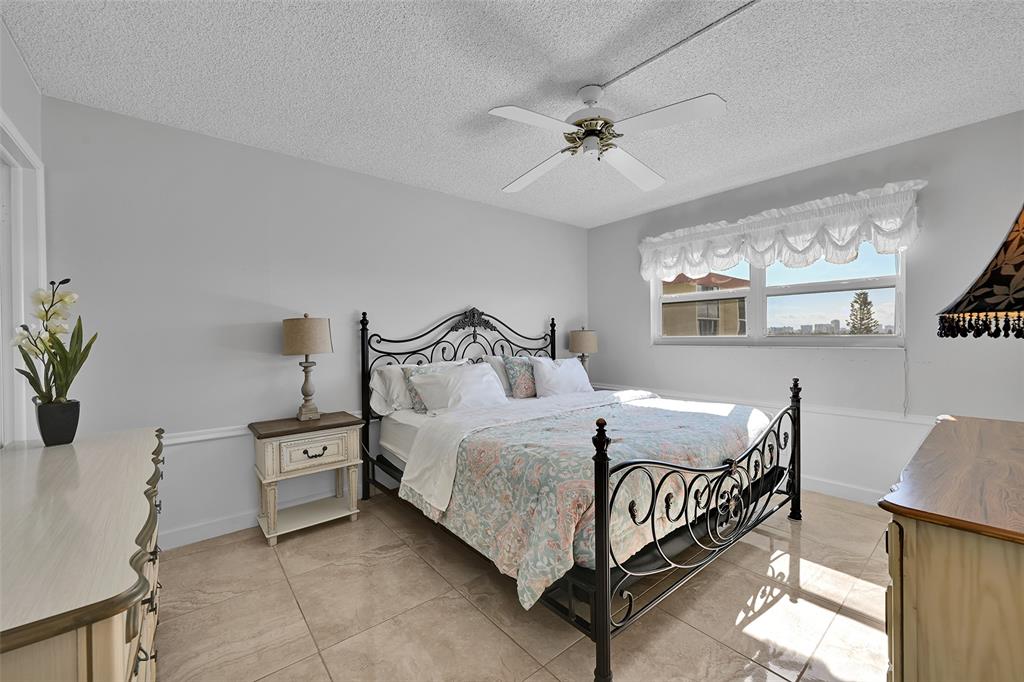 2350 Northeast 14th Street Causeway, Unit 609 Pompano Beach, FL 33062 - Photo 16 of 42 a bedroom with a bed and window