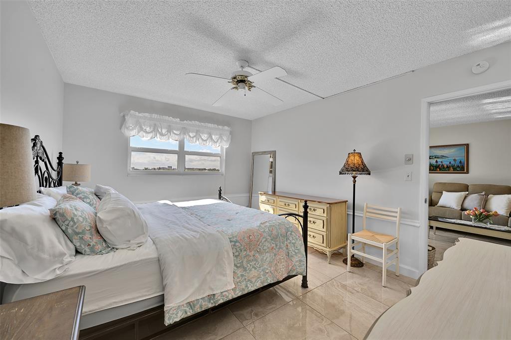 2350 Northeast 14th Street Causeway, Unit 609 Pompano Beach, FL 33062 - Photo 17 of 42 a bedroom with a bed and wooden floor