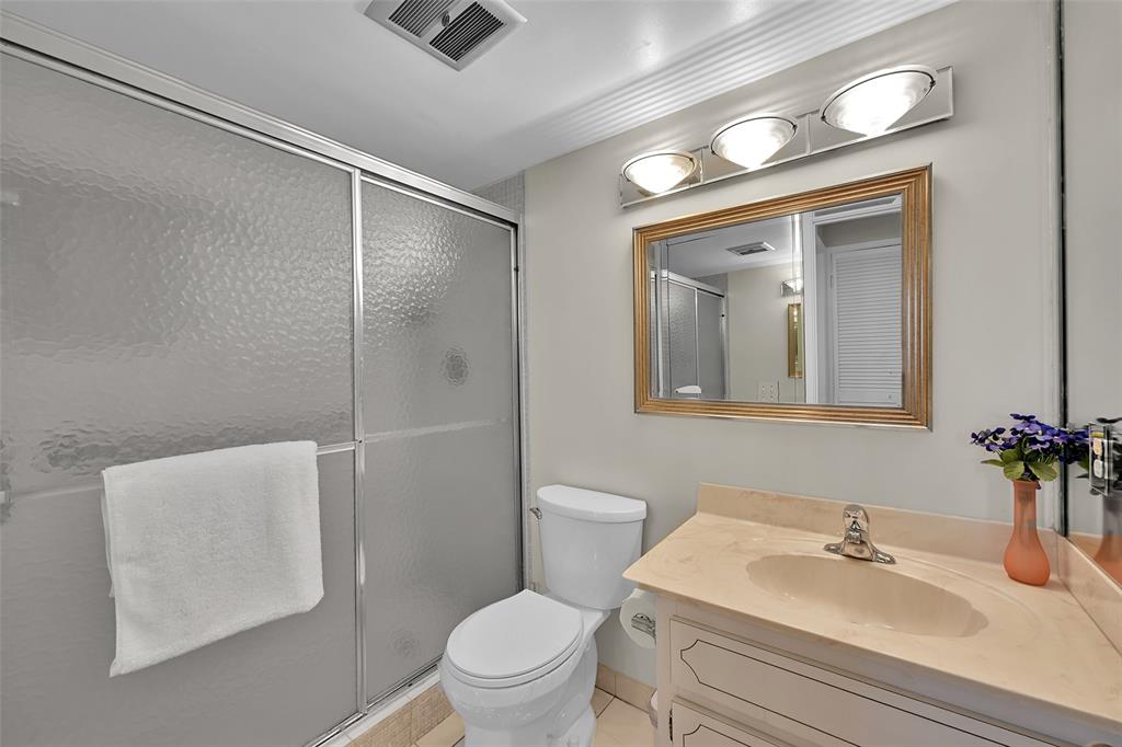 2350 Northeast 14th Street Causeway, Unit 609 Pompano Beach, FL 33062 - Photo 18 of 42 a bathroom with a sink toilet and mirror