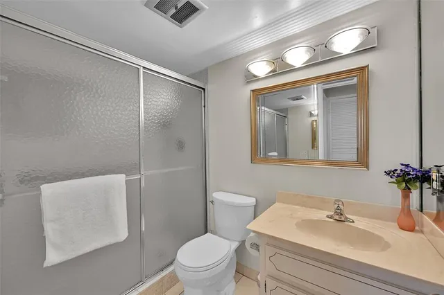 a bathroom with a sink toilet and mirror