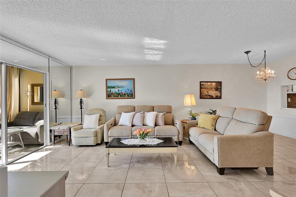2350 Northeast 14th Street Causeway, Unit 609 Pompano Beach, FL 33062 - Photo 2 of 42 a living room with furniture and a table