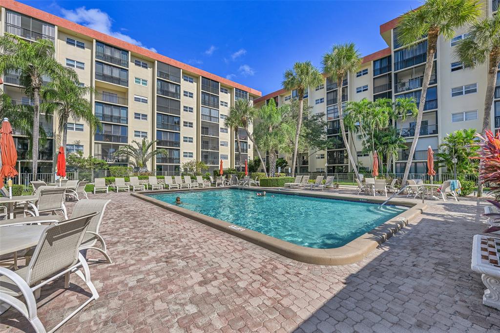 2350 Northeast 14th Street Causeway, Unit 609 Pompano Beach, FL 33062 - Photo 23 of 42 a view of a patio with a table and chairs and plants