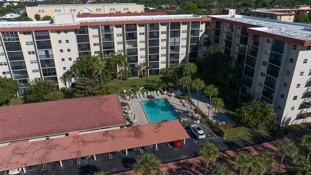 an aerial view of a house with a yard and lake view