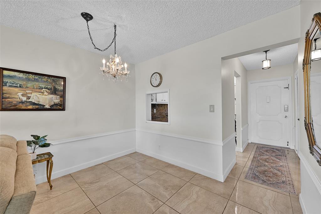 2350 Northeast 14th Street Causeway, Unit 609 Pompano Beach, FL 33062 - Photo 9 of 42 a view of a hallway with furniture and chandelier