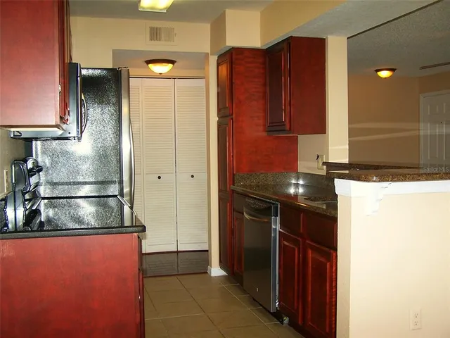 a kitchen with a refrigerator and a microwave