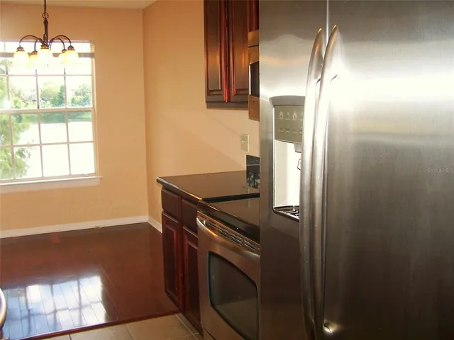 a bathroom with a granite countertop toilet and a sink