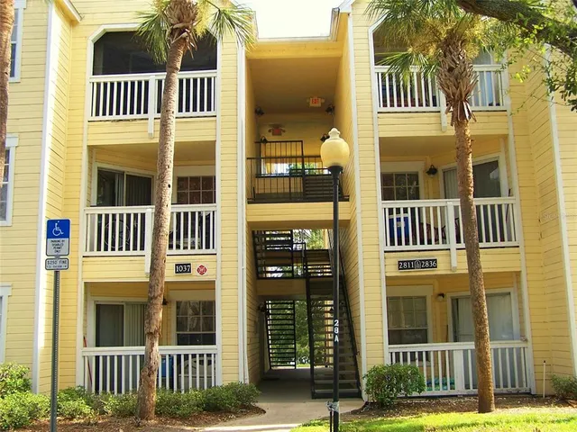 a living room with furniture and a ceiling fan