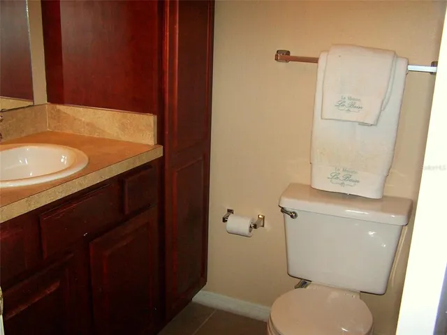 a view of a lake with a big yard and palm trees