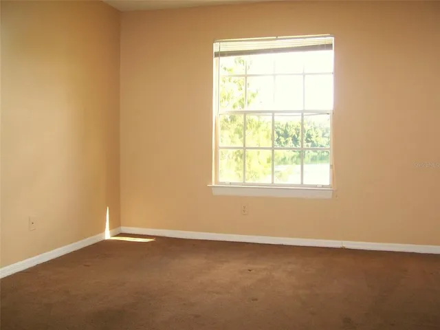a view of a house with swimming pool and sitting area