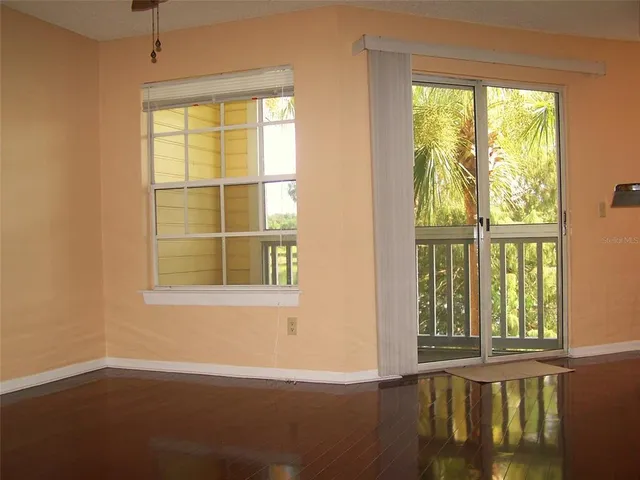 a kitchen with stainless steel appliances granite countertop a sink a stove and a wooden floors