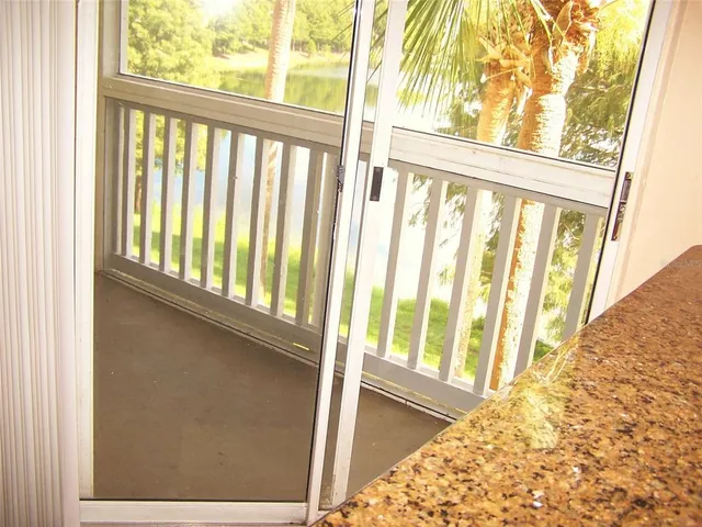 a kitchen with granite countertop a refrigerator and a sink
