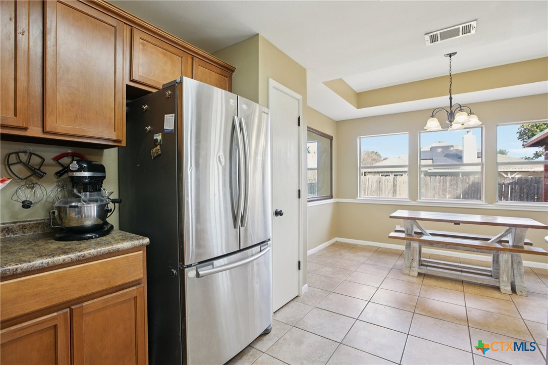 7114 Pappus Court Temple, TX 76502 - Photo 14 of 28 a kitchen with stainless steel appliances a refrigerator and a counter top space