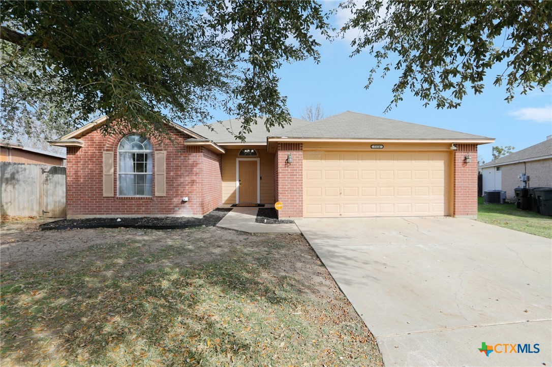 7114 Pappus Court Temple, TX 76502 - Photo 2 of 28 a view of a house with a yard and garage