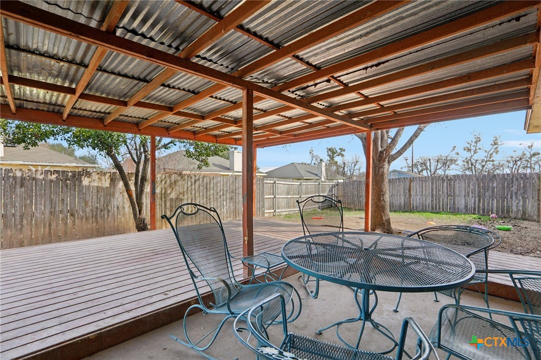 7114 Pappus Court Temple, TX 76502 - Photo 23 of 28 a view of a patio with table and chairs and wooden floor