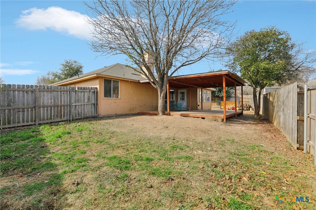 7114 Pappus Court Temple, TX 76502 - Photo 26 of 28 a backyard of a house with wooden fence and large trees