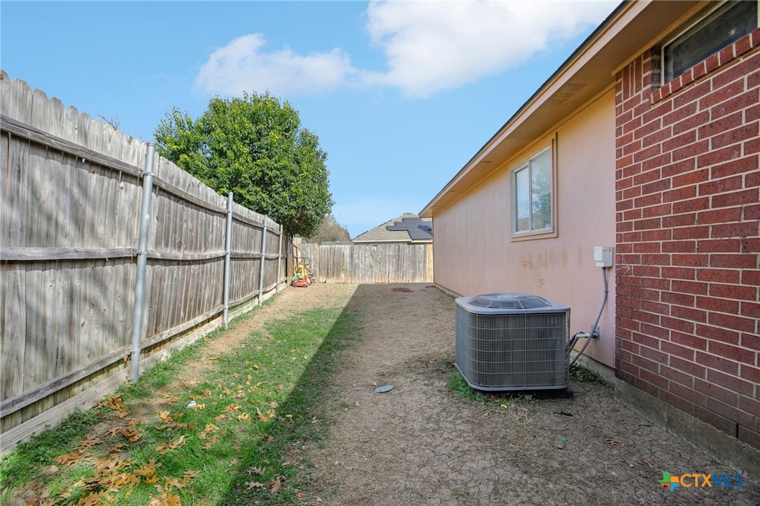 7114 Pappus Court Temple, TX 76502 - Photo 27 of 28 a view of backyard with cabin and wooden fence