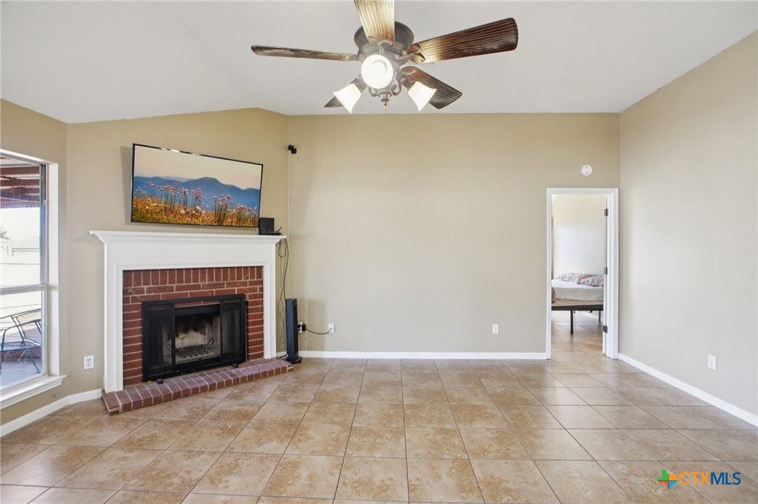 7114 Pappus Court Temple, TX 76502 - Photo 7 of 28 a living room with furniture and a fireplace