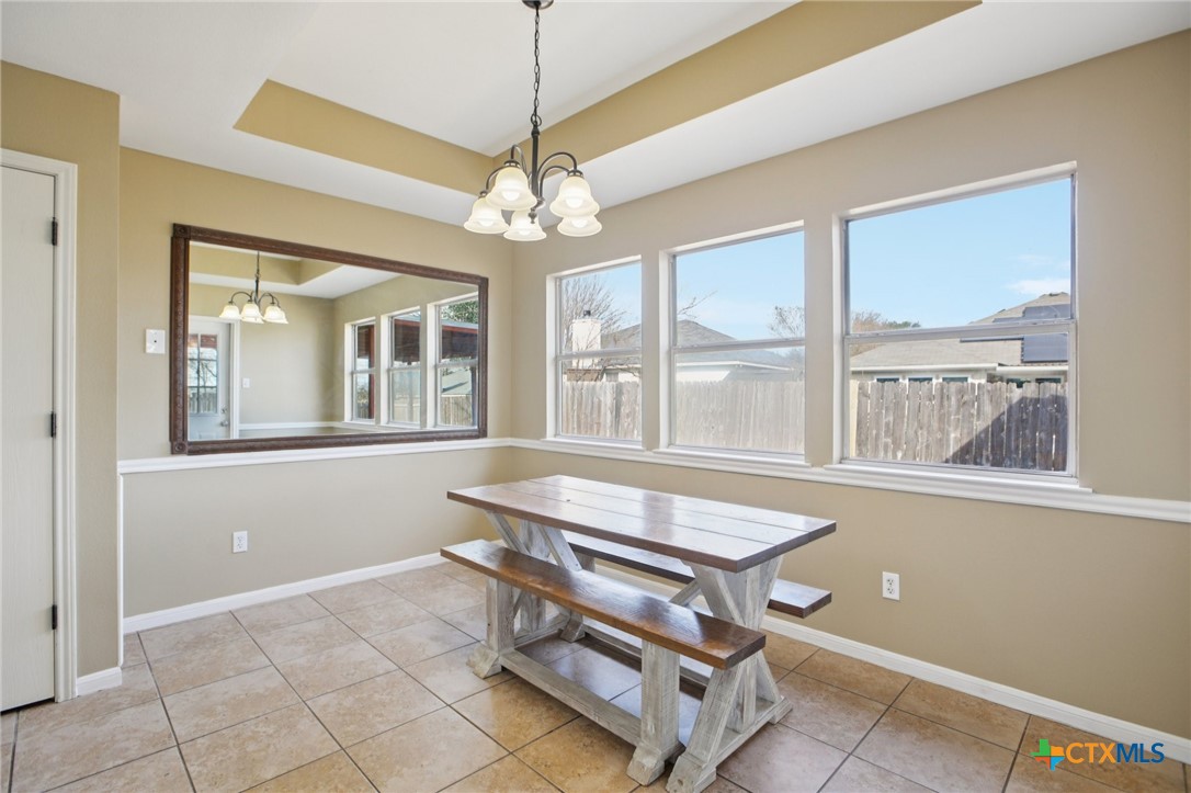 7114 Pappus Court Temple, TX 76502 - Photo 9 of 28 a dining room with chandelier and wooden floor