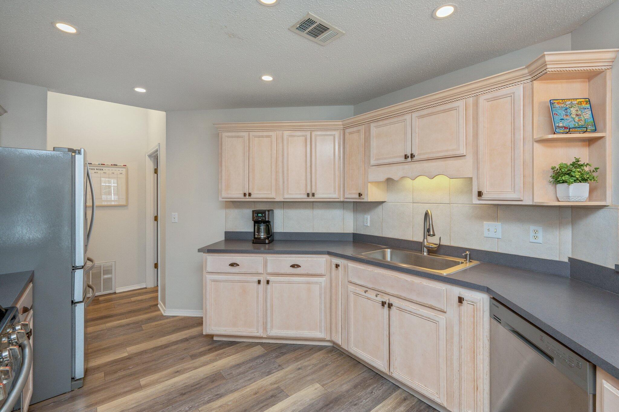 730 Denise Drive Crestview, FL 32536 - Photo 13 of 40 a kitchen with a sink dishwasher a refrigerator and cabinets