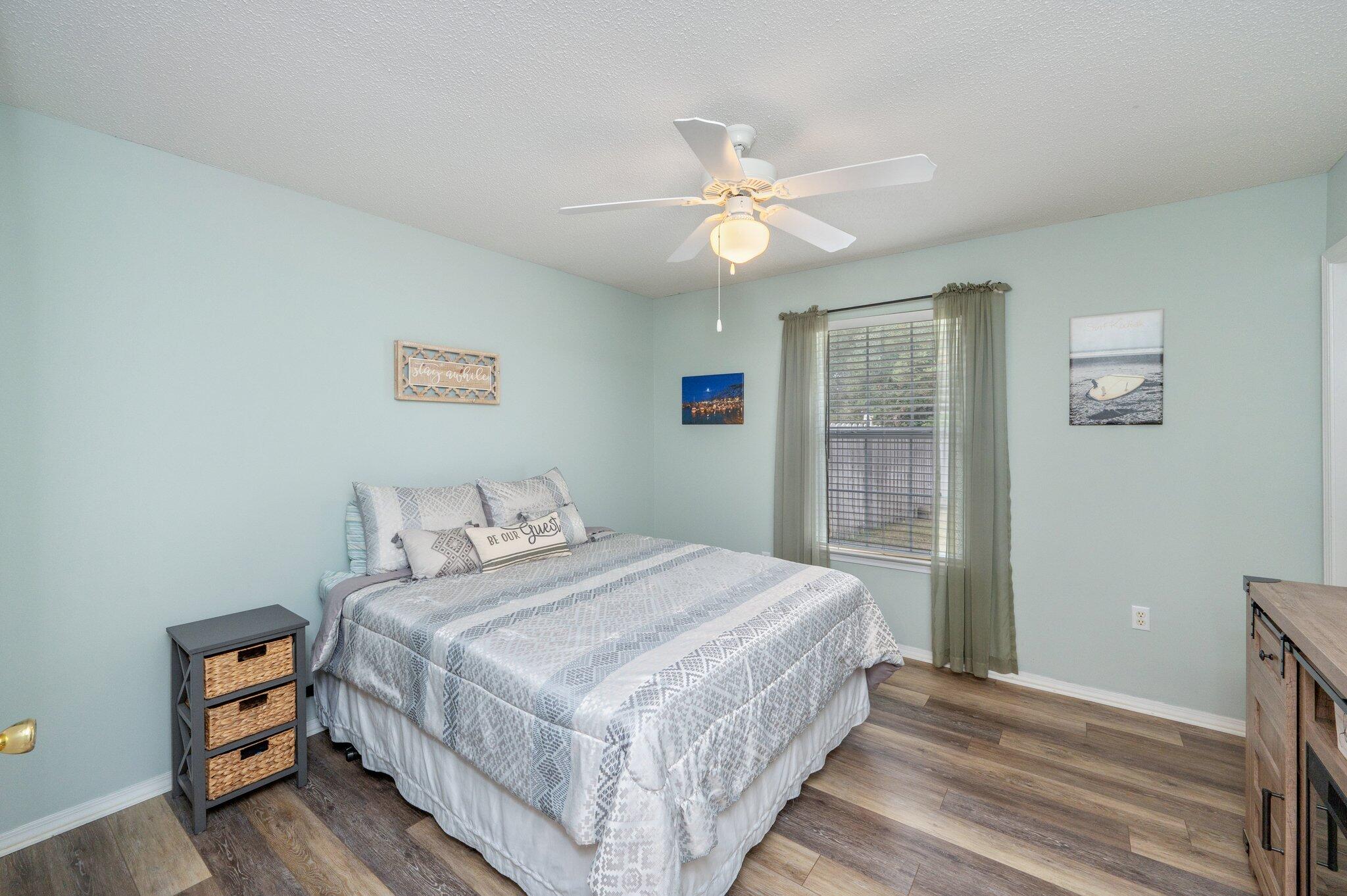 730 Denise Drive Crestview, FL 32536 - Photo 25 of 40 a bedroom with a bed and a chandelier