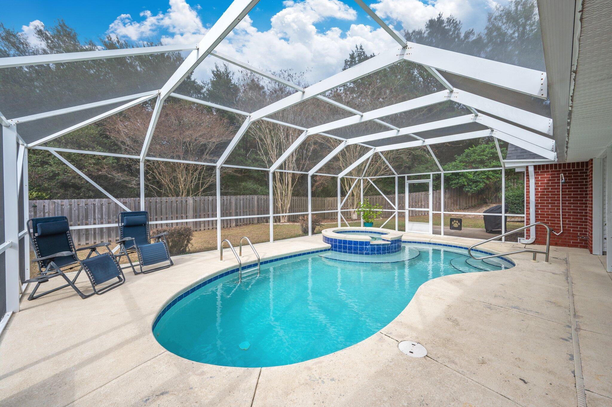 730 Denise Drive Crestview, FL 32536 - Photo 34 of 40 a view of a swimming pool with a lounge chair