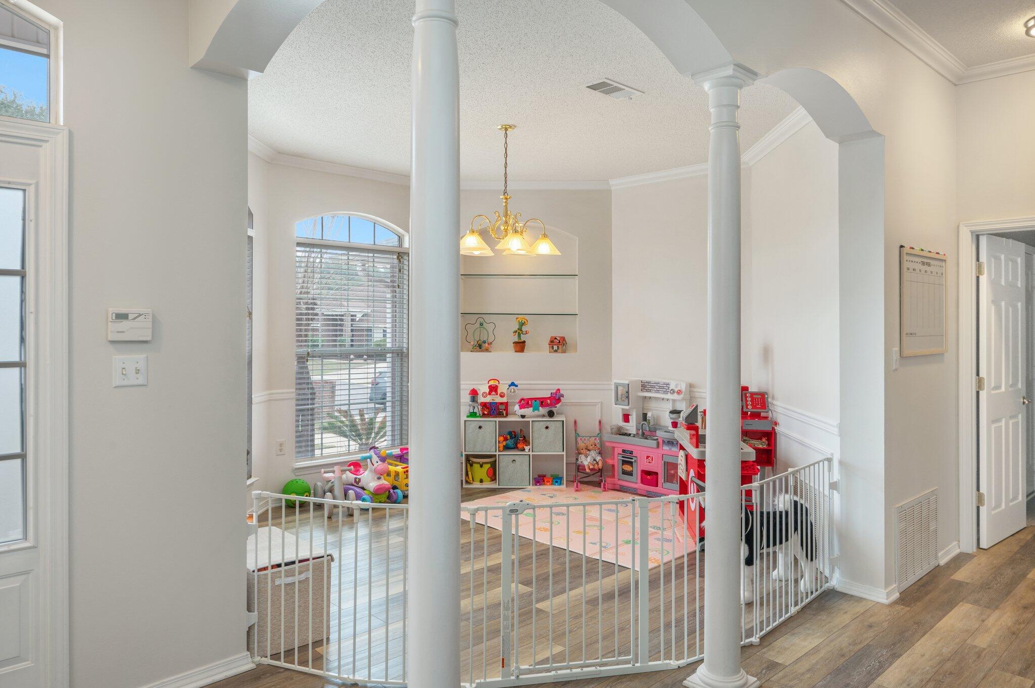 730 Denise Drive Crestview, FL 32536 - Photo 5 of 40 a view of kids room with baby crib and toys