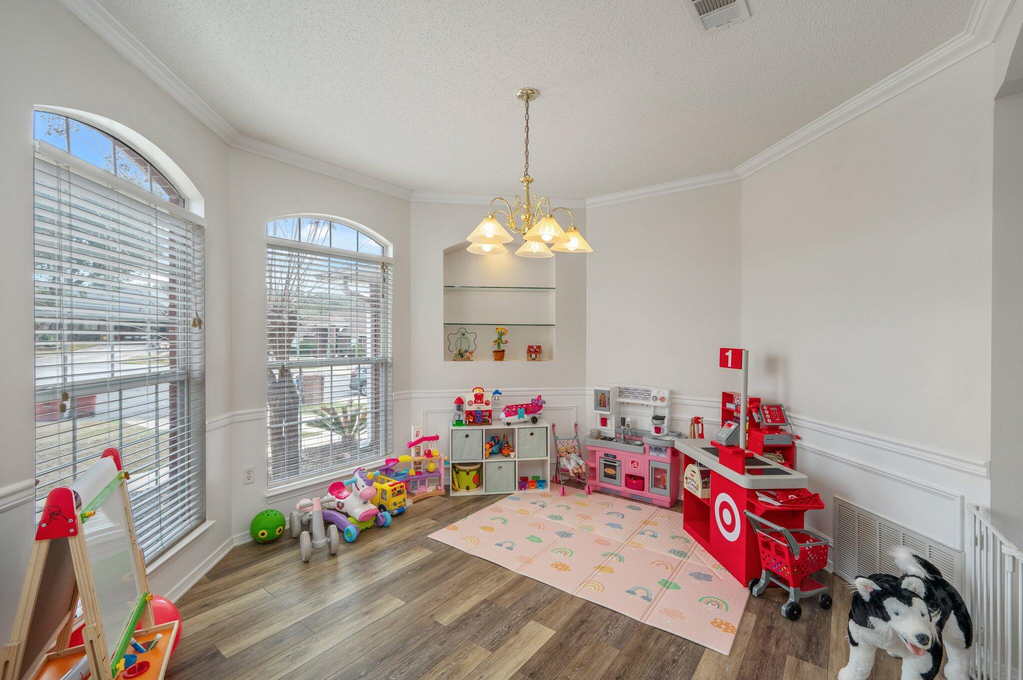 730 Denise Drive Crestview, FL 32536 - Photo 6 of 40 a living room with furniture and a chandelier