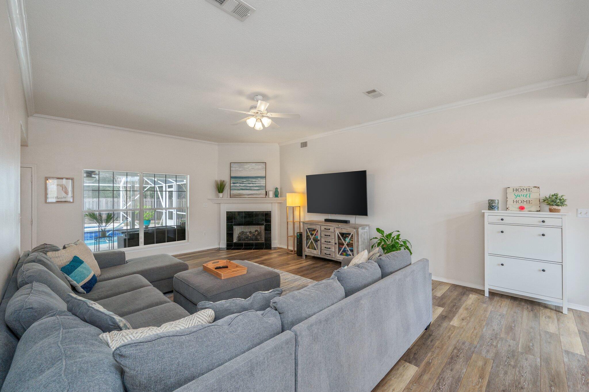 730 Denise Drive Crestview, FL 32536 - Photo 8 of 40 a living room with furniture a flat screen tv and a fireplace